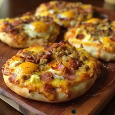 small pizzas with cheese and bacon on a cutting board, ready to be eaten