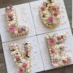 four decorated cookies are arranged in the shape of the letter e, with flowers on them