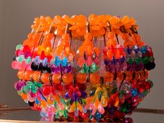 a bunch of colorful hair clips on top of a glass table next to a mirror