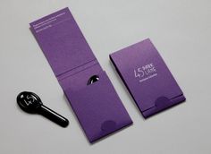 a pair of scissors sitting on top of a purple box next to it's packaging