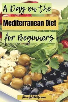 a white plate topped with olives, cheese and other vegetables next to the words a day on the mediterranean diet for beginners