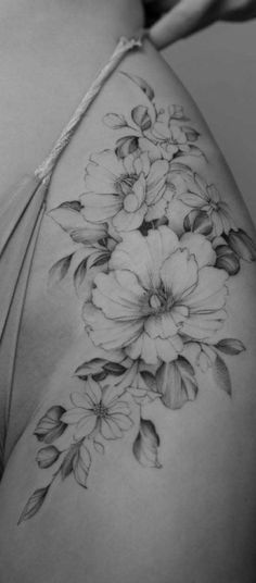 the back of a woman's stomach with flowers on it