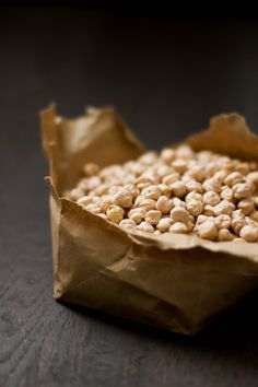 a brown paper bag filled with peanuts on top of a table