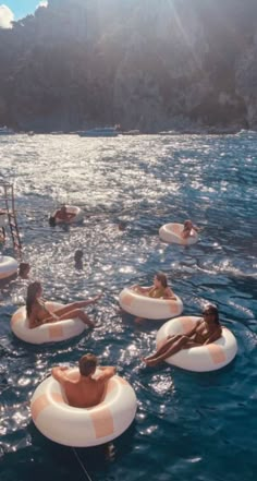 some people are floating on inflatables in the water