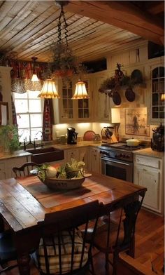 a wooden table sitting in the middle of a kitchen