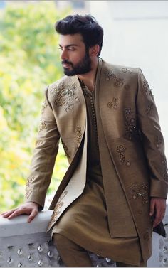 a man with a beard wearing a brown suit