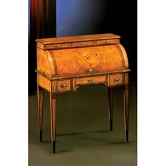 an old wooden desk with writing on the top and drawer at the bottom, sitting in front of a window