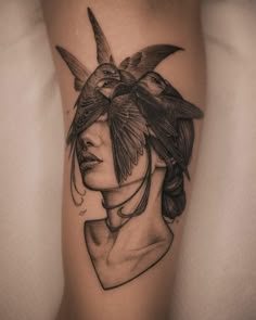 a woman with a bird on her head is shown in black and white tattoo art