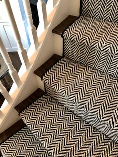 some stairs with black and white rugs on them