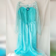 a blue dress hanging on a white wall