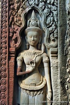 an intricately carved statue in the corner of a building