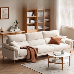 a living room with a white couch and coffee table