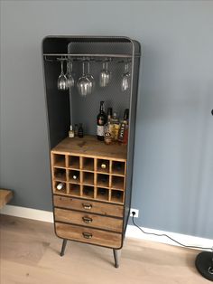 a cabinet with wine glasses and bottles on it