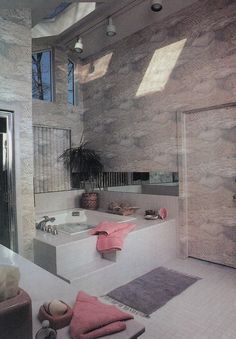 a large bathroom with two sinks and a bathtub in the middle of the room