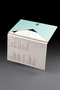 an open box with papers in it on a gray surface, showing the contents inside