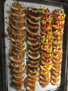 there are many donuts with candy on them in the shape of apple slices and candies