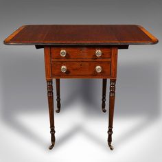 an antique wooden table with two drawers on one side and three brass knobs on the other