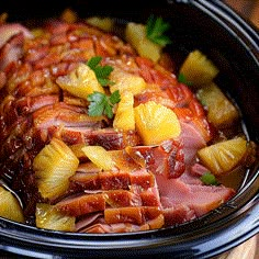 ham and pineapples are cooked in the slow cooker