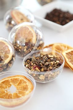 several bowls filled with granola and orange slices