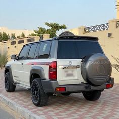 a white suv parked on the side of a road