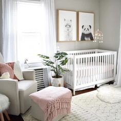 a baby's room with a white crib, chair and pictures on the wall