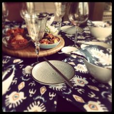 a table topped with plates and glasses filled with food