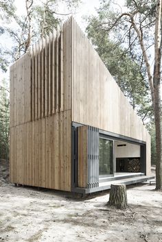 the house is made out of wood and has been designed to look like a triangular structure