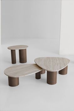 three wooden tables sitting next to each other