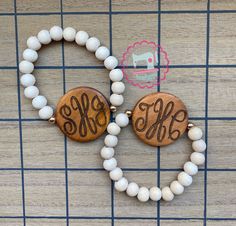 two personalized wooden beaded bracelets with white beads