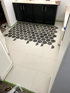 a bathroom with black and white tiles on the floor