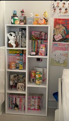 a white book shelf filled with lots of books