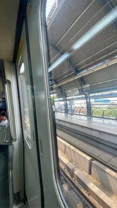 the inside of a subway train with people sitting on seats and looking out the window