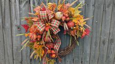 a happy thanksgiving wreath with sunflowers and fall leaves on a wooden door frame