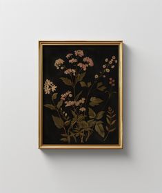 a painting hanging on the wall with flowers in it