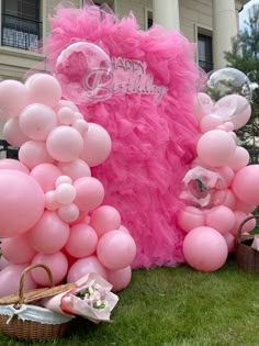 pink balloons and decorations in front of a building