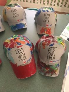 five hats with the words best dad ever painted on them are sitting on a table