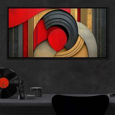 an abstract painting on the wall next to a record player and a table with records