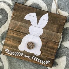 a wooden sign with an image of a rabbit on it