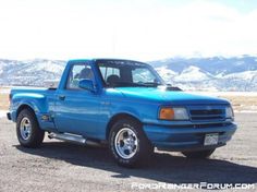 a blue pick up truck is parked in the desert