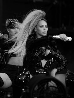 two women on stage with one holding a microphone