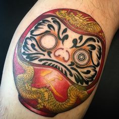 a close up of a person's leg with a tattoo design on the thigh