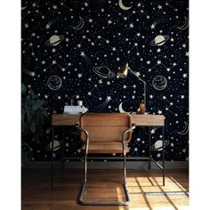 a chair and desk in front of a wall with stars