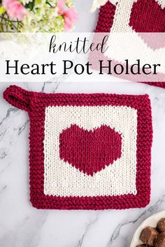 two crocheted heart pot holders sitting on top of a marble counter with flowers in the background