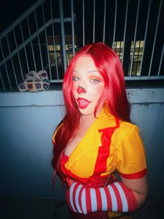 a woman with red hair and clown makeup