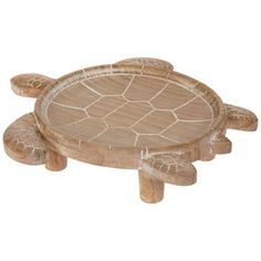 a small wooden turtle sitting on top of a table