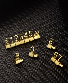 some gold numbers are sitting on a black surface