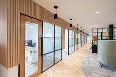 an office with wooden walls and glass doors