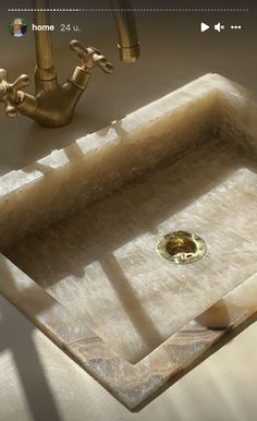 a bathroom sink sitting under a faucet next to a mirror