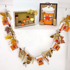 an arrangement of fall themed items displayed on a table