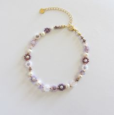 Purple flower bead bracelet, Gold filled jewelry, Daisy bracelet, Dainty handmade bracelet 18k gold plated brass chain and clasp. To determine your exact wrist/ankle size, get a tape measure! The bracelet is made of purple, white and pink seed beads size 10/0 (about 2mm diameter), glass beads, freshwater pearls measuring about 4mm and a 18k gold plated clasp and extension chain. Cute and delicate daisy bracelet with pearls will add a light touch to your casual and holiday outfits! Lobster clasp and extender for length adjustment and easy removal. Easy Beads Bracelets, Purple Pearl Bracelet, Purple Flower Bracelet, Cute Bracelet Ideas Bead, Diy Gold Jewelry, Purple Seed Bead Bracelet, Flower Bead Bracelet, Bracelet With Pearls, Purple Beaded Bracelets